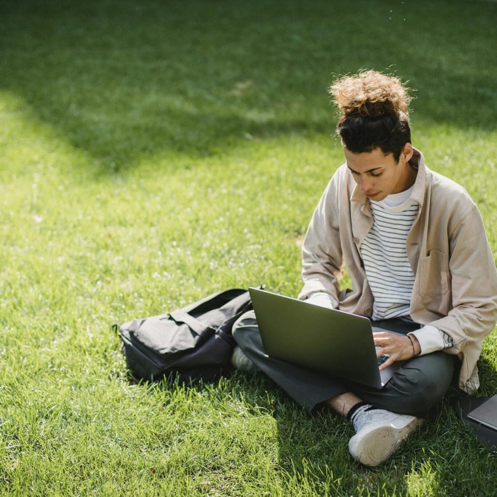 a-young-man-sits-on-the-grass-1364x1364